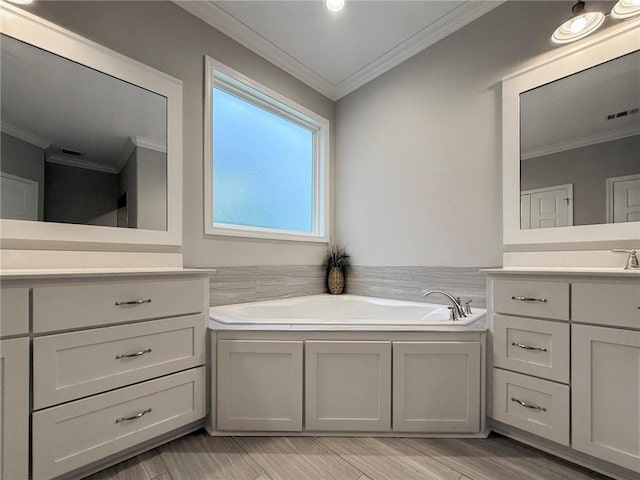 373 Harbour Island Cir, Waverly, GA 31565 - bathroom with crown molding, vanity, a bath, and wood finished floors