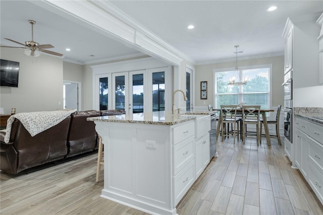 373 Harbour Island Cir, Waverly, GA 31565 - kitchen with ceiling fan, recessed lighting, ornamental molding, light stone countertops, and white cabinetry