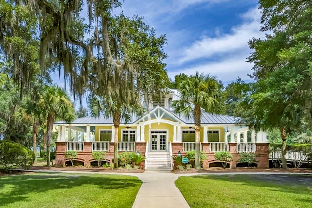373 Harbour Island Cir, Waverly, GA 31565 - view of front of house with a front lawn, a standing seam roof, and a metal roof