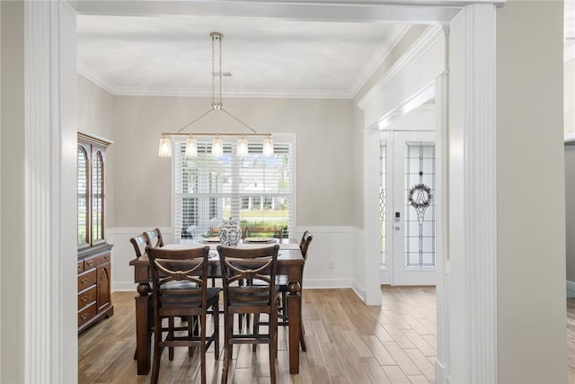 373 Harbour Island Cir, Waverly, GA 31565 - dining space featuring wood finished floors, a wainscoted wall, crown molding, and a decorative wall