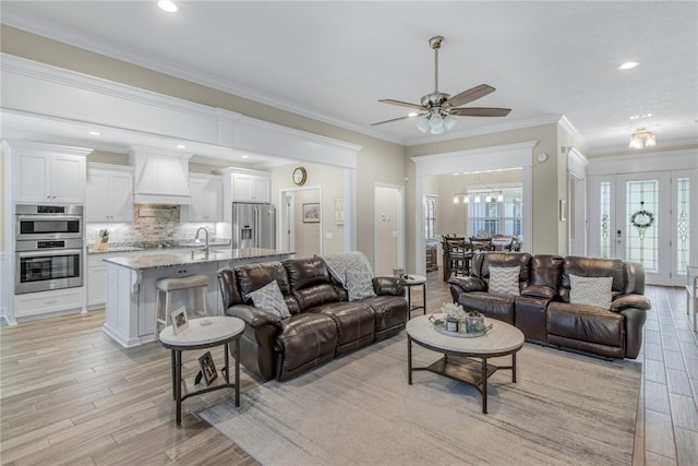 373 Harbour Island Cir, Waverly, GA 31565 - living room featuring ornamental molding, light wood finished floors, a ceiling fan, and recessed lighting
