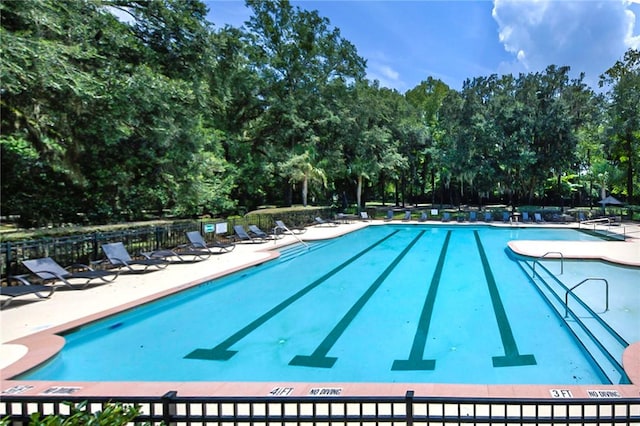 373 Harbour Island Cir, Waverly, GA 31565 - community pool with view of wooded area and a patio area