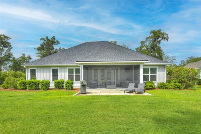373 Harbour Island Cir, Waverly, GA 31565 - rear view of house featuring a sunroom, a yard, a shingled roof, and a patio
