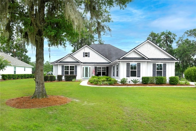 373 Harbour Island Cir, Waverly, GA 31565 - view of front of house with board and batten siding and a front yard