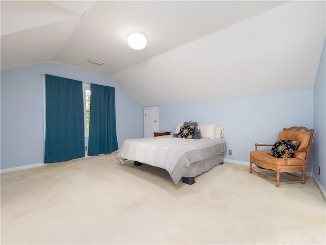 bedroom featuring lofted ceiling, carpet, and baseboards