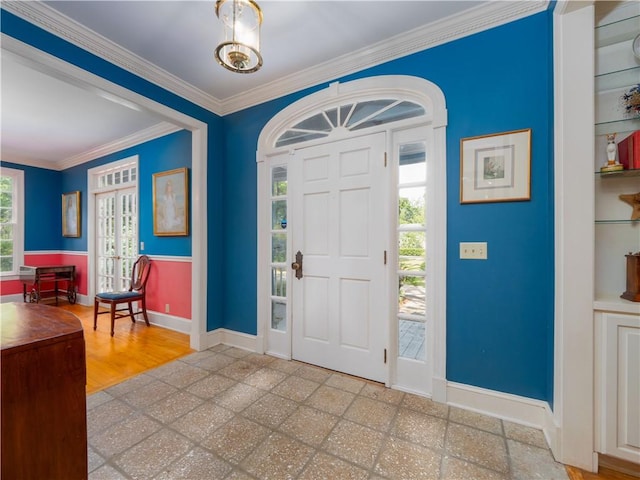 foyer with baseboards and ornamental molding