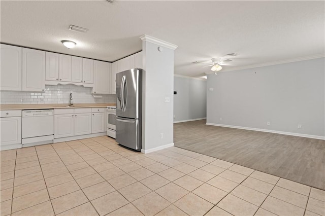 701 Third Ave, Saint Simons Island, GA 31522 - kitchen with a sink, crown molding, white appliances, and light countertops