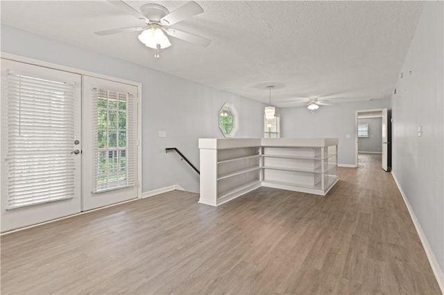 701 Third Ave, Saint Simons Island, GA 31522 - interior space with ceiling fan, a textured ceiling, baseboards, and wood finished floors