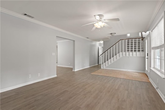 701 Third Ave, Saint Simons Island, GA 31522 - unfurnished living room featuring ceiling fan, stairs, visible vents, and wood finished floors
