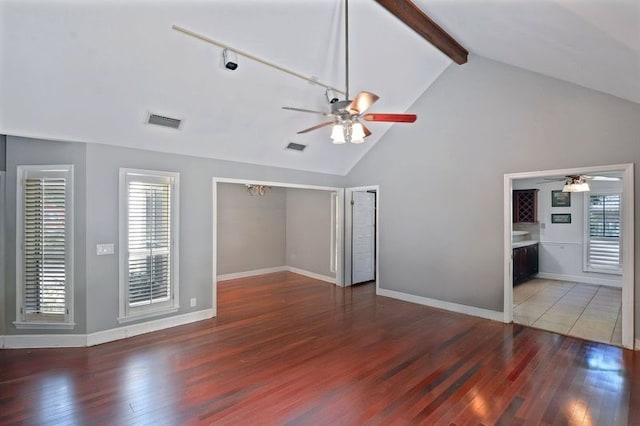 104 Cay Trce, Brunswick, GA 31525 - unfurnished living room with a ceiling fan, beam ceiling, wood finished floors, high vaulted ceiling, and baseboards