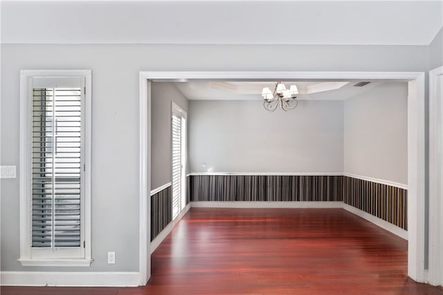 104 Cay Trce, Brunswick, GA 31525 - unfurnished dining area featuring wood finished floors, a chandelier, and baseboards