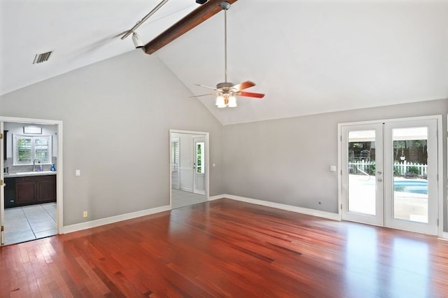 104 Cay Trce, Brunswick, GA 31525 - unfurnished living room with high vaulted ceiling, french doors, light wood-type flooring, plenty of natural light, and a ceiling fan