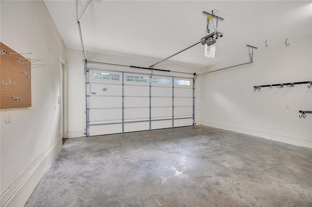 11826 Old Demere Rd, Saint Simons Island, GA 31522 - garage featuring a garage door opener and baseboards