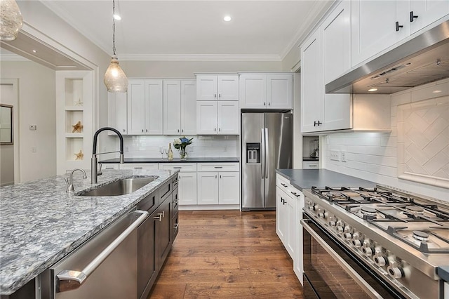 11826 Old Demere Rd, Saint Simons Island, GA 31522 - kitchen with stainless steel appliances, extractor fan, backsplash, pendant lighting, and ornamental molding