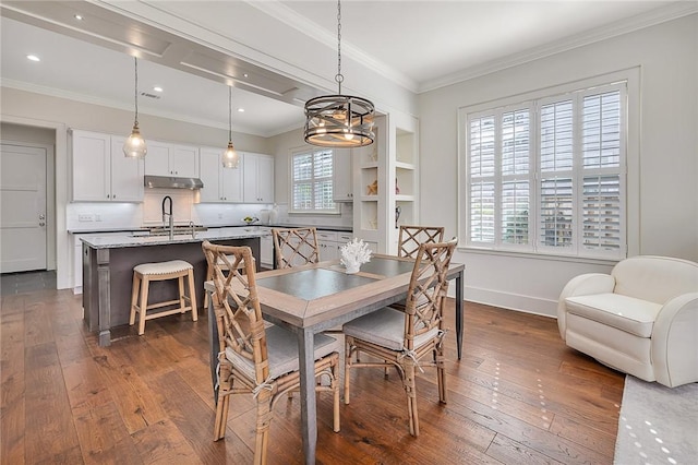 11826 Old Demere Rd, Saint Simons Island, GA 31522 - dining space with dark wood-style floors, ornamental molding, recessed lighting, and a chandelier