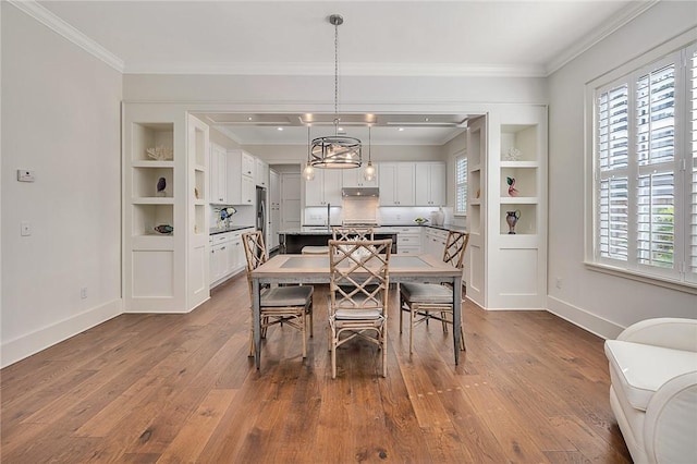 11826 Old Demere Rd, Saint Simons Island, GA 31522 - dining space featuring dark wood finished floors and crown molding