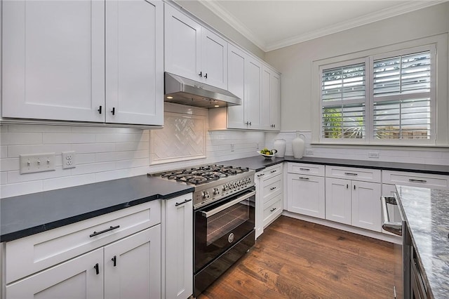 11826 Old Demere Rd, Saint Simons Island, GA 31522 - kitchen with gas range, under cabinet range hood, ornamental molding, dark countertops, and white cabinets