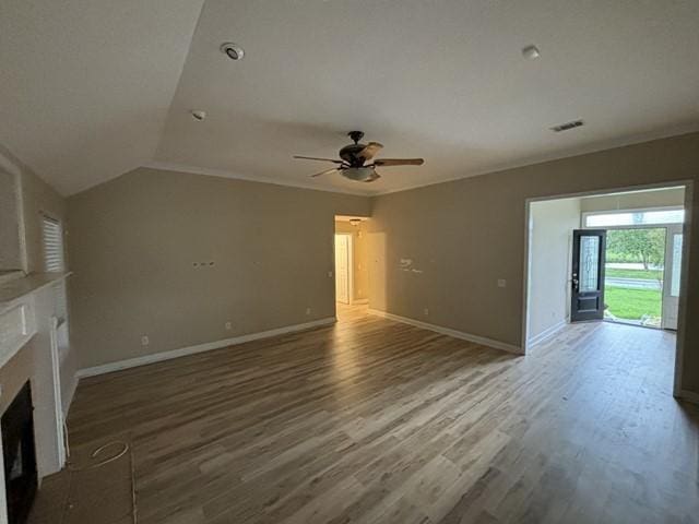 unfurnished living room with hardwood / wood-style flooring, ceiling fan, and vaulted ceiling