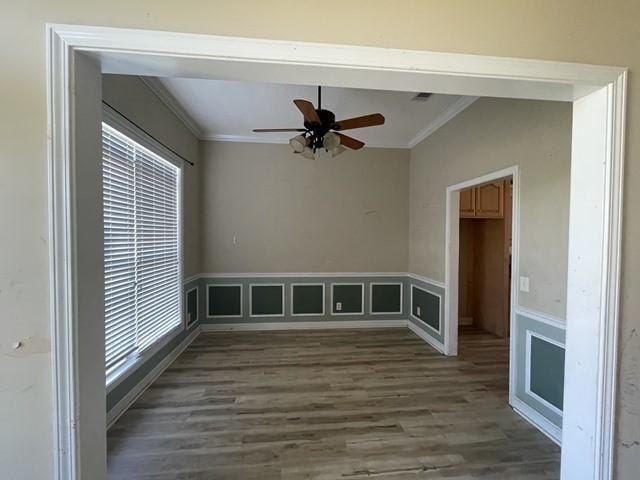 empty room featuring hardwood / wood-style flooring, ceiling fan, and crown molding