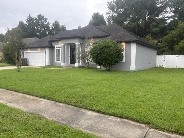 view of front facade featuring a garage and a front lawn