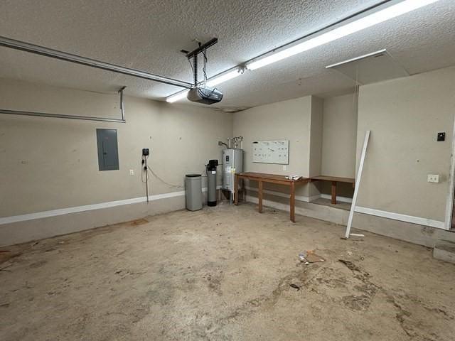 garage with electric water heater, electric panel, and a garage door opener