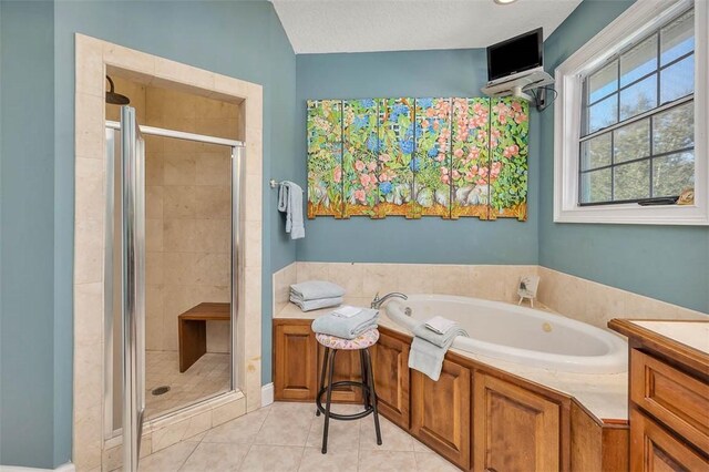 bathroom with tile patterned floors, vanity, a textured ceiling, and plus walk in shower