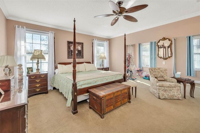 bedroom with multiple windows, ceiling fan, and carpet floors