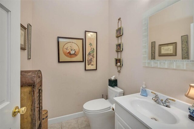 bathroom with tile patterned floors, vanity, and toilet