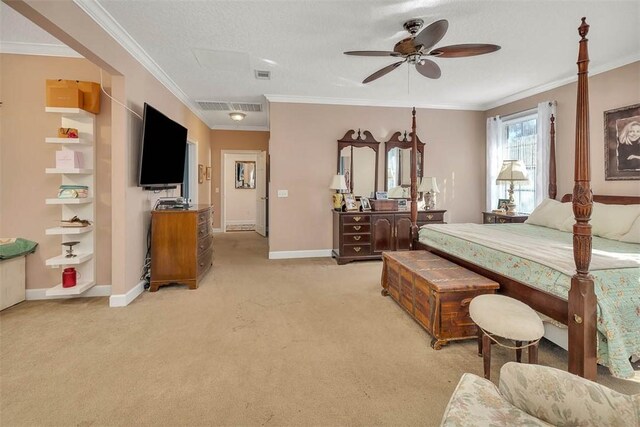 carpeted bedroom with a textured ceiling, ceiling fan, and crown molding