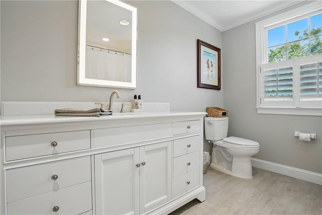 206 Dunbar Dr, Saint Simons Island, GA 31522 - full bathroom with baseboards, wood finished floors, toilet, crown molding, and vanity