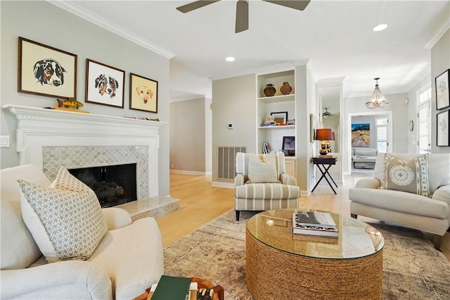 living room featuring visible vents, ornamental molding, wood finished floors, recessed lighting, and a ceiling fan