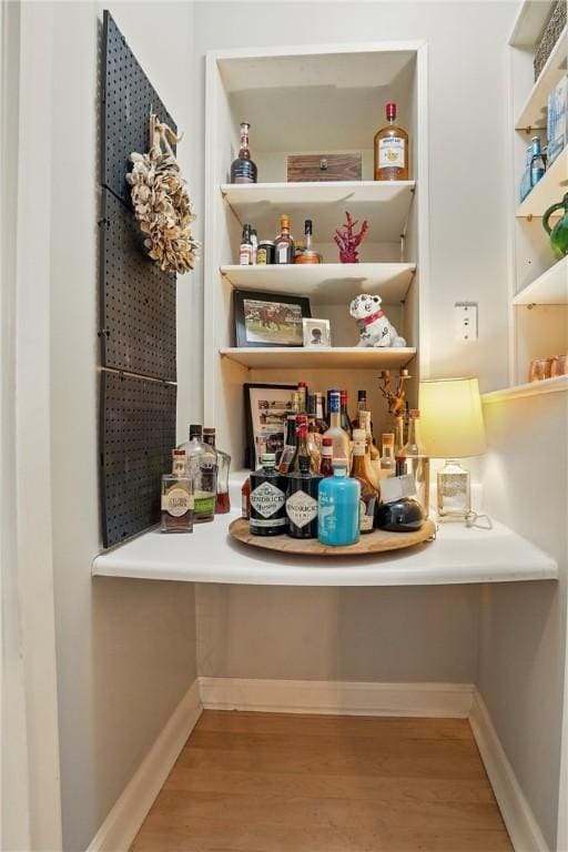 room details featuring baseboards and wood finished floors