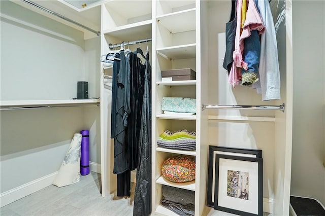 walk in closet featuring wood finished floors
