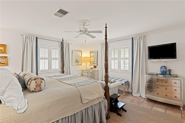 bedroom with light tile patterned flooring, a ceiling fan, visible vents, and ornamental molding