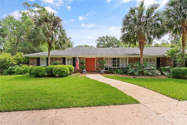 ranch-style home with a front lawn and brick siding
