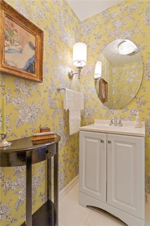 bathroom with tile patterned flooring, vanity, and wallpapered walls
