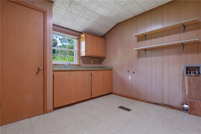 kitchen with wooden walls and sink