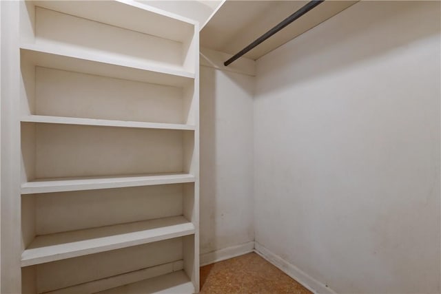 walk in closet with carpet