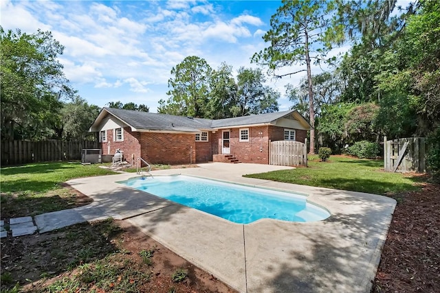 view of swimming pool with a yard and a patio area