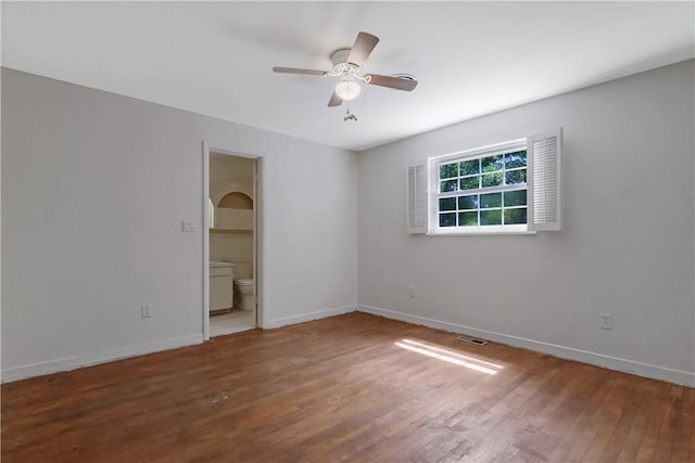 unfurnished bedroom with hardwood / wood-style flooring, ceiling fan, and ensuite bathroom