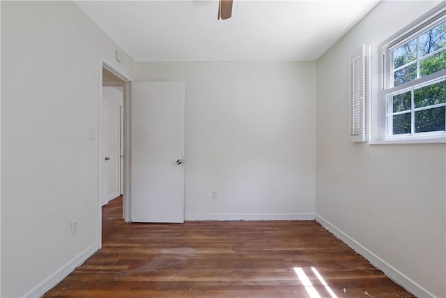 unfurnished room featuring ceiling fan and dark wood-type flooring