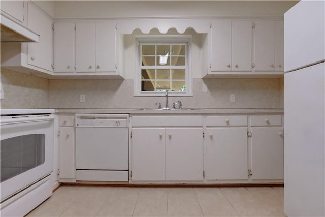 kitchen with white cabinets, white appliances, sink, and light tile patterned floors