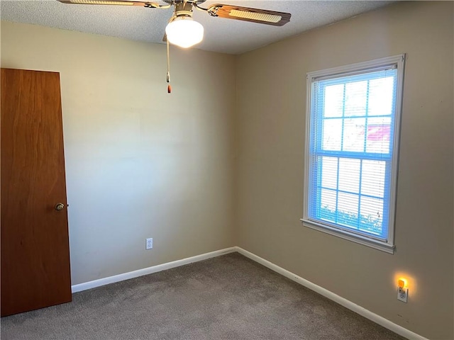 empty room featuring carpet flooring, ceiling fan, and a textured ceiling