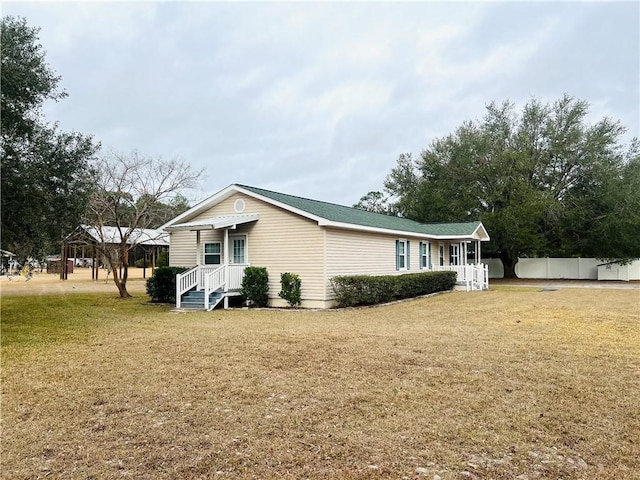 view of side of home with a lawn