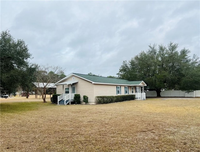 view of property exterior with a lawn