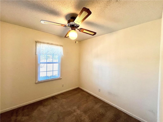 carpeted spare room featuring ceiling fan and a textured ceiling