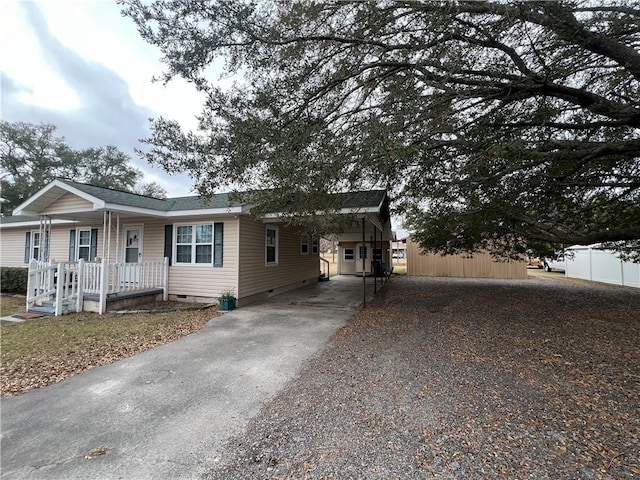 view of front of home with a porch and a carport