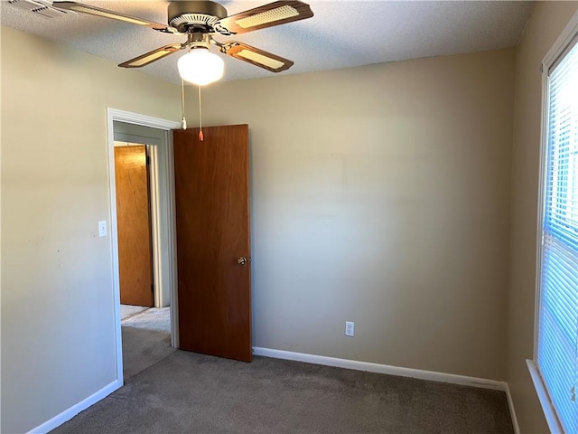 spare room with ceiling fan and carpet floors