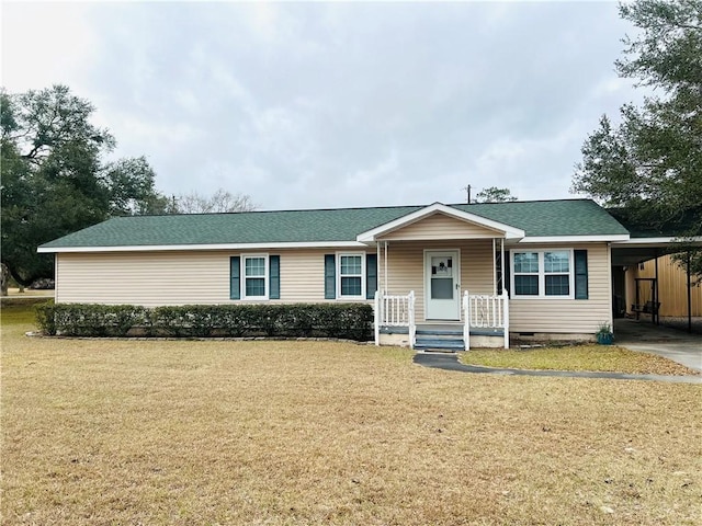 ranch-style house featuring a carport and a front lawn