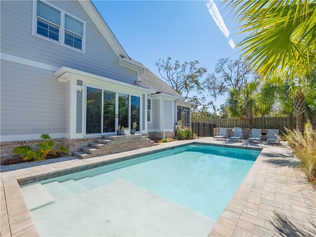 view of pool featuring a patio, a fenced in pool, and fence